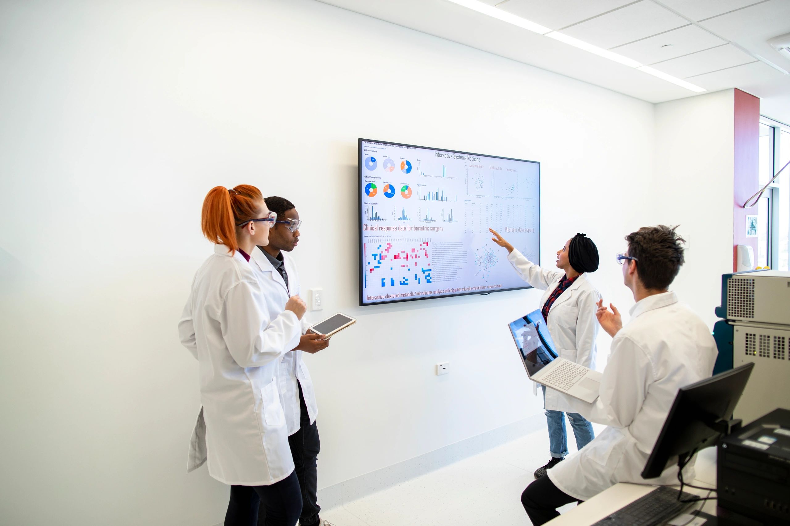 Modern laboratory team collaborating in a clean scientific workspace