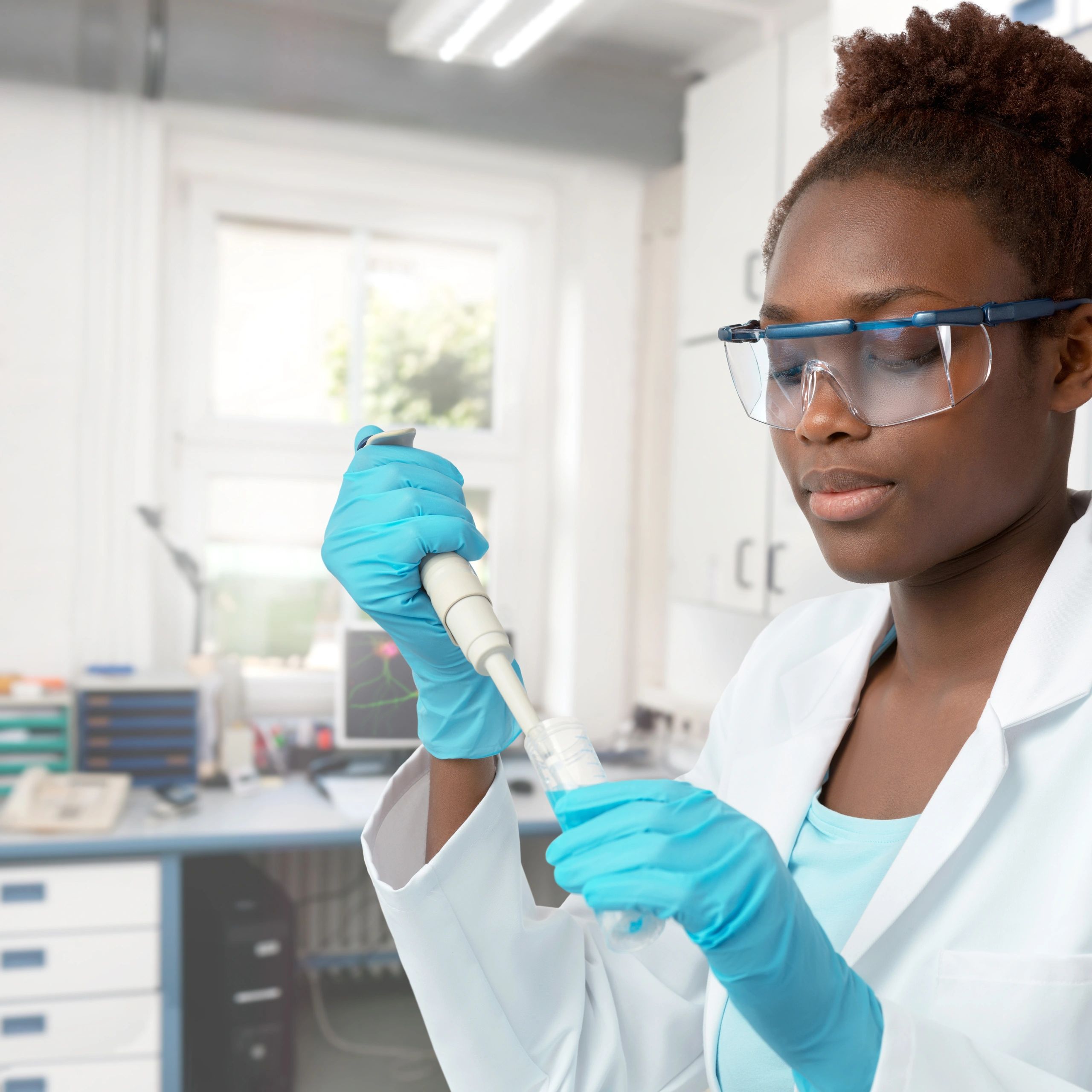 Scientist in protective lab wear working in a modern biotech lab